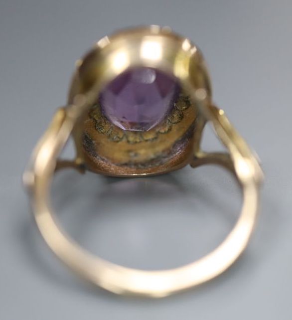 An early 20th century 9ct, amethyst and split pearl set oval dress ring, size N, gross 4.8 grams, (one pearl missing).